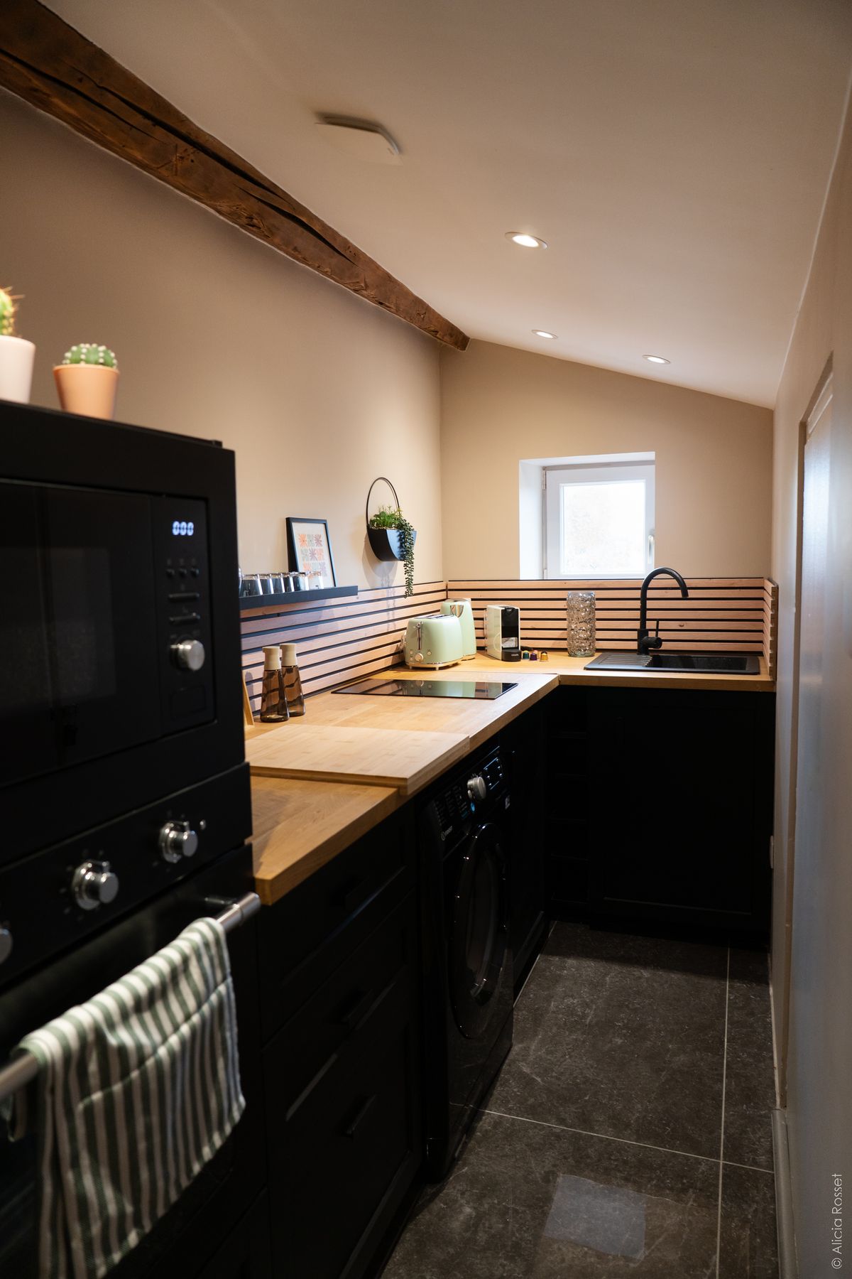 Kitchen — black cabinets & wood countertop