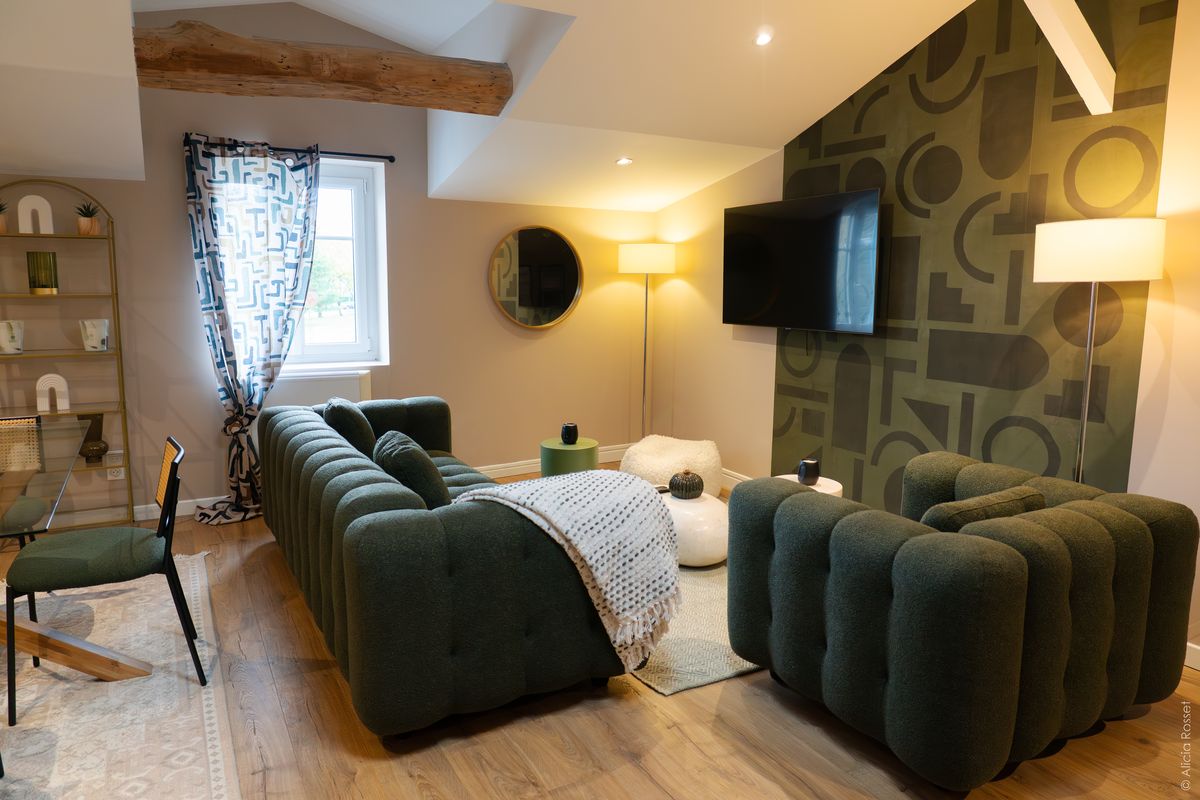 Living room — green boucle sofas & geometric wallpaper